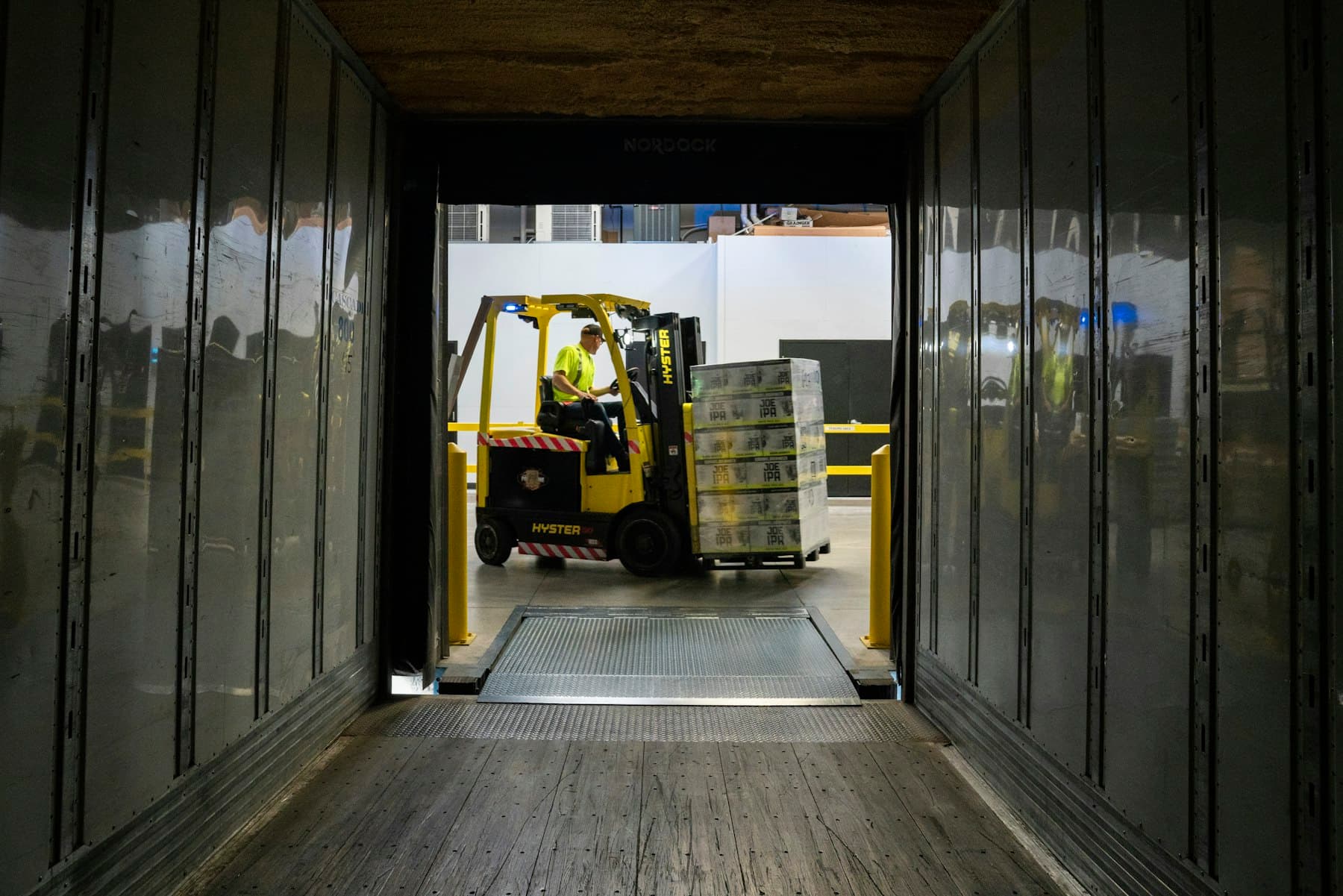 Forklift loading pallets into a truck trailer